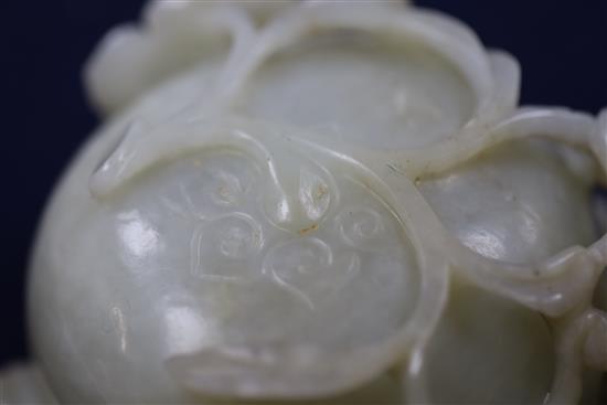 A Chinese pale celadon jade lotus cup, late Ming dynasty, W.13cm, associated wood stand